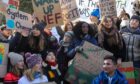 Vanessa Nakate, centre, pictured with other young activists, including Greta Thunberg on her right, during a climate protest in Switzerland