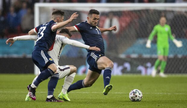 John McGinn and Billy Gilmour take on Mason Mount during last June’s Euro 2020 tie at Wembley