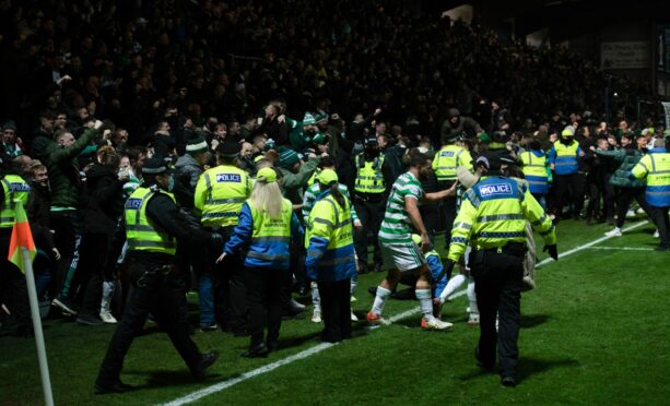 Celtic fans were on the pitch in Dingwall last December