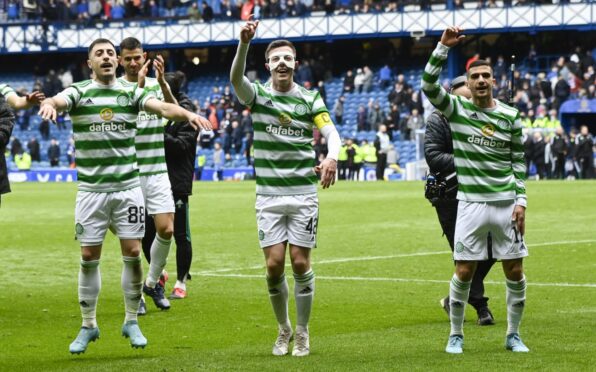 Callum McGregor leads his team-mates in a celebration jig after their win in the last Old Firm league game at Ibrox