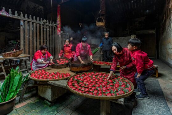 A family  gathers in a farmhouse in Putian in China’s Fujian province to make rice or mung bean dumplings. They use a wooden seal to stamp the word “fortune” or “happiness” into the red dough, and steam the dumplings. This tradition means the new year will be welcomed with reunion and the coming year will be prosperous. Chen Ying’s photograph was a category winner in Pink Lady Food Photographer of the Year awards announced last week