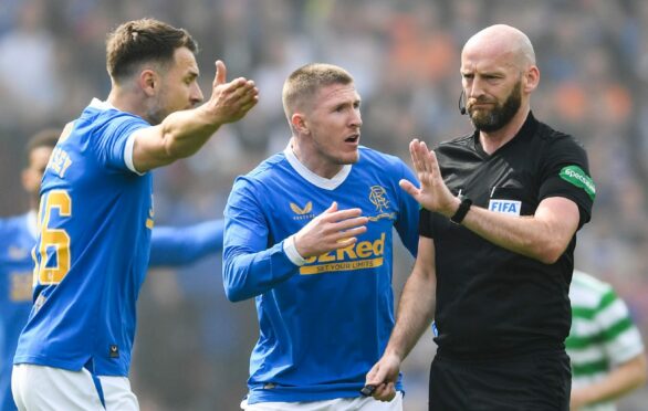 Referee Bobby Madden and John Lundstram and Aaron Ramsey during the Scottish Cup semi-final between Celtic and Rangers at Hampden