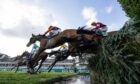 Noble Yeats ridden by Sam Waley-Cohen at the waterjump on their way to victory in the Grand National