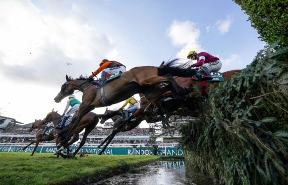 Noble Yeats ridden by Sam Waley-Cohen at the waterjump on their way to victory in the Grand National