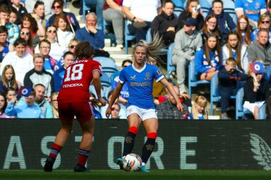 Rangers’ Brogan Hay on the ball against Aberdeen’s Eva Thomson in April as the Ibrox side strode towards a first title