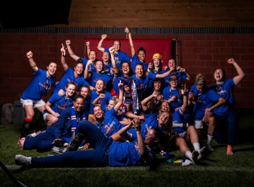 Jubilant Rangers players celebrate their title success and going unbeaten through the whole league season