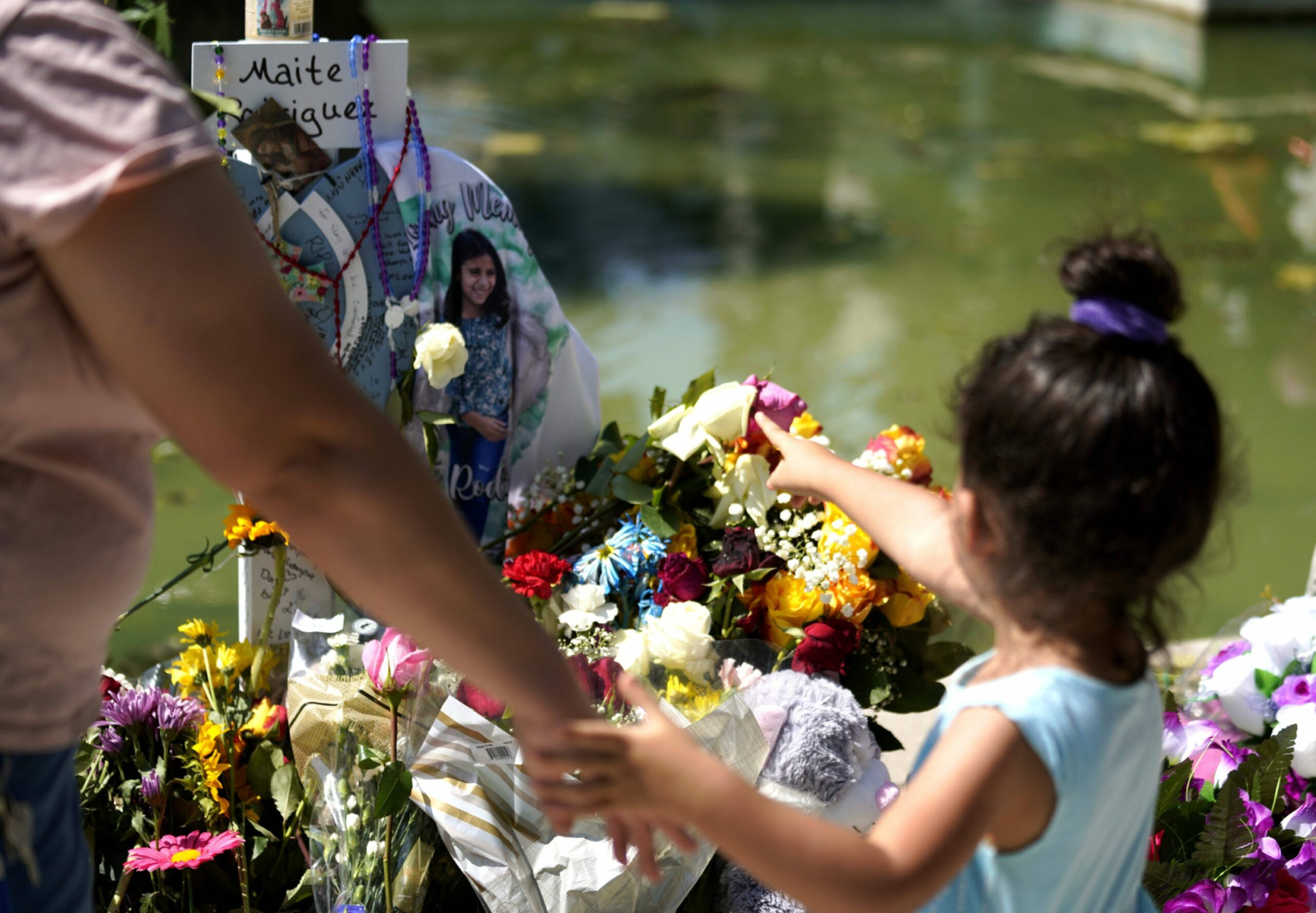 People mourn for victims of a school mass shooting at Town Square in Uvalde, Texas.