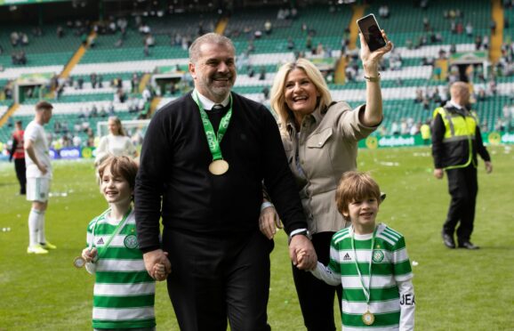 Celtic manager Ange Postecoglou celebrates the title win with his family