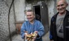 Marina and Oleg share fresh buns in the war zone