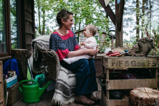 Sarah McLeod with grand-daughter Meadow at her one-room hut in the Stirlingshire hamlet of Carbeth
