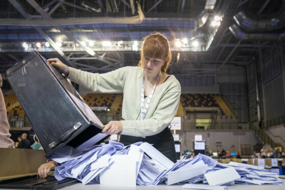 Ballot boxes are opened ready for sorting at the Glasgow City Council election count at the Emirates Arena