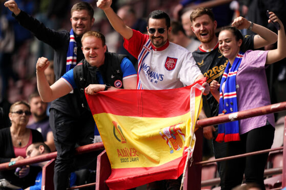 Rangers fans in the stands at Tynecastle 
with a Seville Europa League final flag during the match against Hearts yesterday