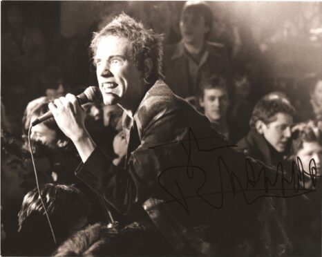 Billy Sloan is in the crowd at Ivanhoe’s as John Lydon, then Johnny Rotten, does his stuff  in Kevin Cummins’ picture