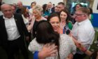 Sinn Fein president Mary Lou McDonald, centre, and vice president Michelle O’Neill, in pink jacket, greet wellwishers after arriving at the count in Magherafelt yesterday.