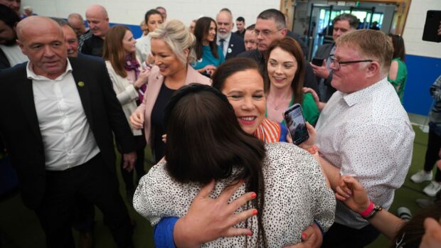 Sinn Fein president Mary Lou McDonald, centre, and vice president Michelle O’Neill, in pink jacket, greet wellwishers after arriving at the count in Magherafelt yesterday.