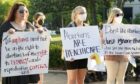 Demonstrators hold signs in support of abortion rights at a protest in Mississippi