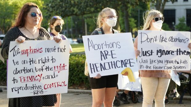 Demonstrators hold signs in support of abortion rights at a protest in Mississippi