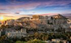 The ancient ruins of the Acropolis on the hills above Athens at sunset