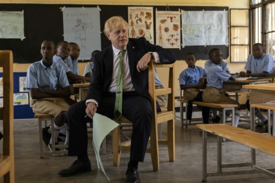 Prime Minister Boris Johnson attends a lesson during a visit to the GS Kacyiru II school on the sidelines of the Commonwealth Heads of Government Meeting on in Kigali, Rwanda.