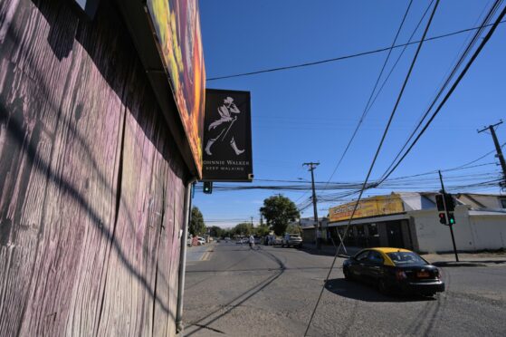 A Johnnie Walker Black Label sign hangs above a liquor store in Talca, Chile, an emerging market for whisky