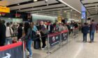 Passengers queue for flights.