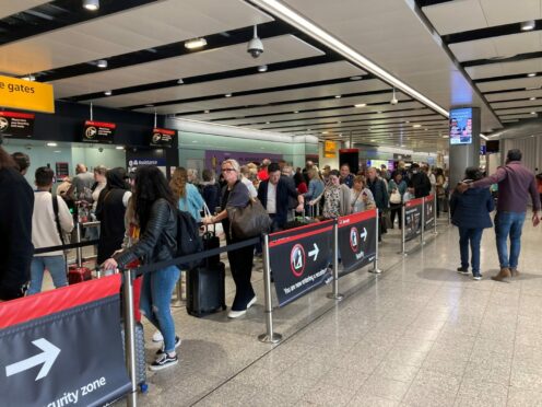 Passengers queue for flights.