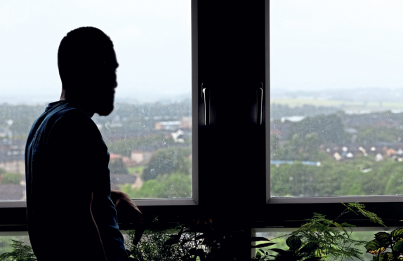 Abdulrahman looks out over Glasgow yesterday after winning first round in fight to avoid being flown to Rwanda