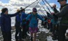 Friends make a guard of honour for Fiona Russell who completes a full set of Munros on Beinn na Lap