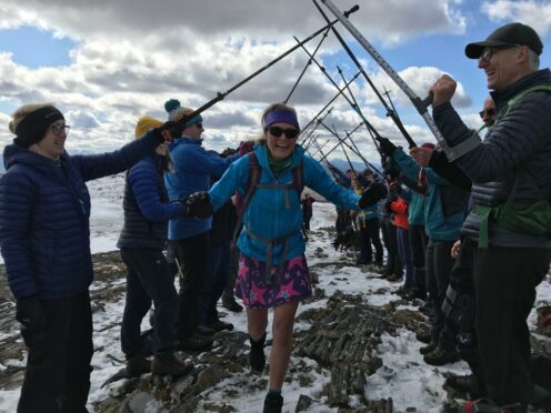 Friends make a guard of honour for Fiona Russell who completes a full set of Munros on Beinn na Lap
