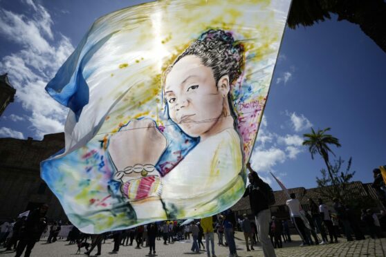 Historical Pact candidate Gustavo Petro holds a flag with images of his running mate Francia Marquez before a rally in Zipaquira, Colombia.