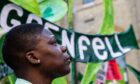 A woman attends the fifth anniversary of the Grenfell tower fire in London on June 14. The blaze claimed the lives of 72 residents