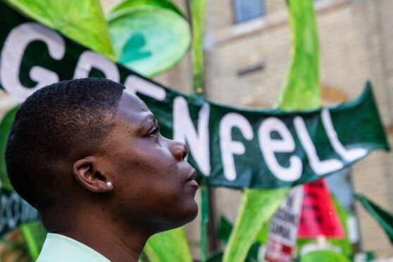 A woman attends the fifth anniversary of the Grenfell tower fire in London on June 14. The blaze claimed the lives of 72 residents