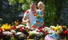 Mourners in Kremenchuk lay flowers for the victims of the cruise missile attack on a shopping centre which claimed 18 lives on Monday