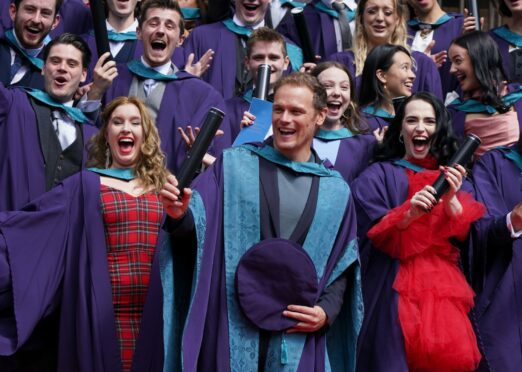 Outlander actor Sam Heughan 
with his honorary doctorate from the Royal Conservatoire of Scotland alongside other graduates 
in Glasgow 
on Thursday
