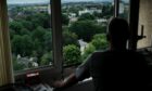 From his 17th floor flat, a resident looks over the leafy enclave in Paisley where Liz Truss once lived.