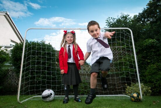 Ollie and Emily Rose in their garden at home in Lanarkshire.