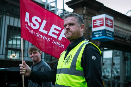 Members of ASLEF train driver's union forming a picket line at the entrance to Edinburgh Waverley station, as train strikes took place the country.