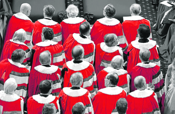 Peers wearing their parliamentary robes attend the state opening of Parliament at Westminster.