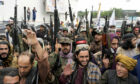 Taliban fighters celebrate one year since they seized the Afghan capital, Kabul, in front of the U.S. Embassy in last Monday