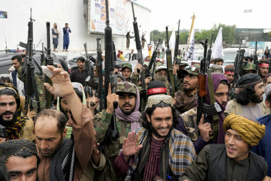 Taliban fighters celebrate one year since they seized the Afghan capital, Kabul, in front of the U.S. Embassy in last Monday