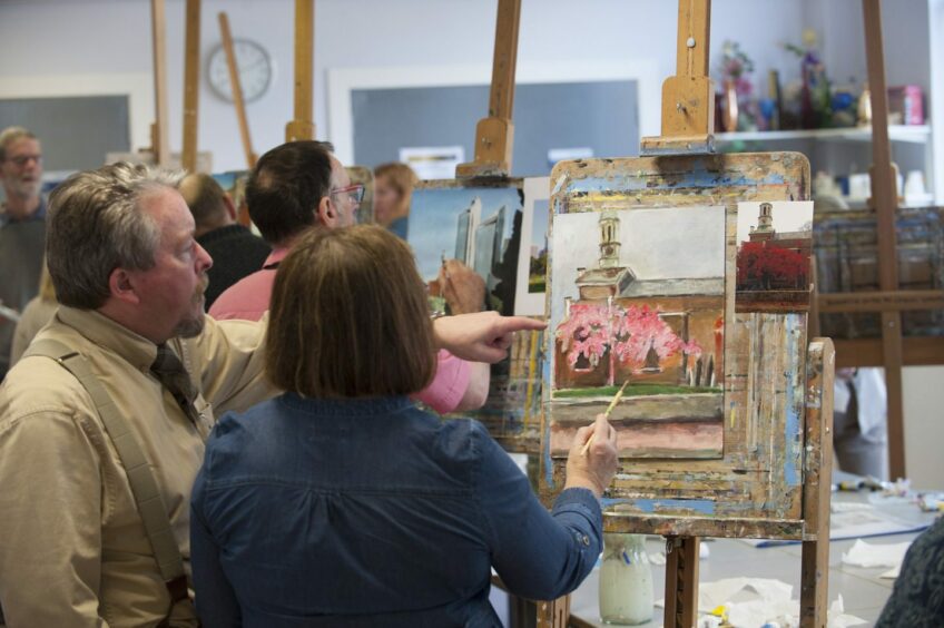 Older students take part in a painting class.