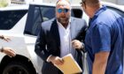 Infowars’ Alex Jones heads into the Texas courthouse during his trial last week