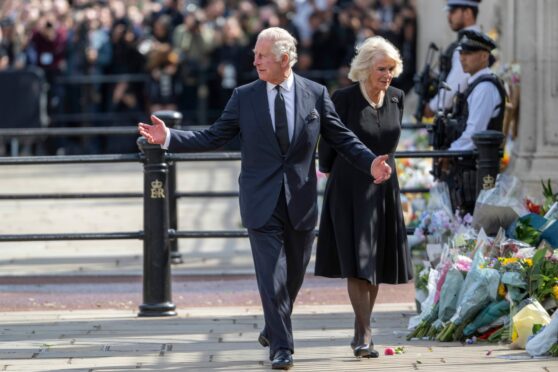 King Charles III and Queen consort Camilla view floral tributes to the late Queen at Buckingham Palace on Friday