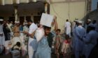 People affected by floods receive relief aid distributed by the Al Khidmat Foundation in Nowshera District, Garhi Momin Village, Khyber Pakhtunkhwa province.