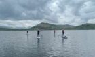 Rachel and friends show off their paddleboarding skills on Loch Tay