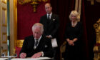 King Charles signs formal oath with his wife Camilla and son William at ceremony yesterday