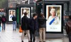 Tributes to Queen Elizabeth II on bus stops on Princes Street in Edinburgh on Friday
