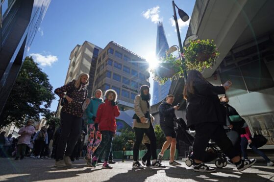 People wait in the long and winding queue near the Shard on the way to Westminster Hall to pay respects to the Queen yesterday morning