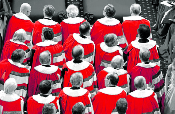 Some of the 755 sitting members of the House of Lords in ermine cloaks at a state opening of parliament