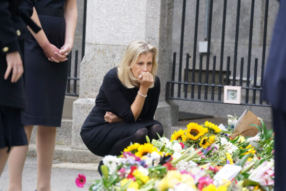 Sophie, Countess of Wessex, views the messages and floral tributes left by members of the public outside Balmoral Castle yesterday